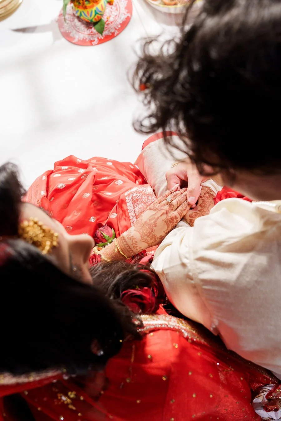 Casey holding Amrita's hand showing the engagement ring