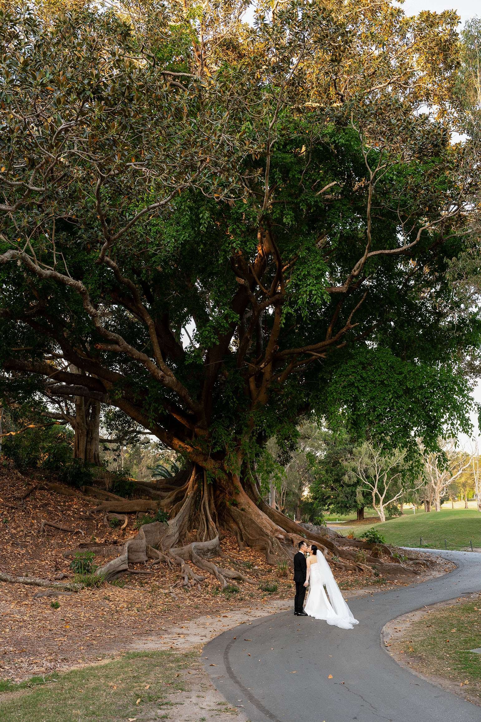 Wendy and Alex kissing on a pathway