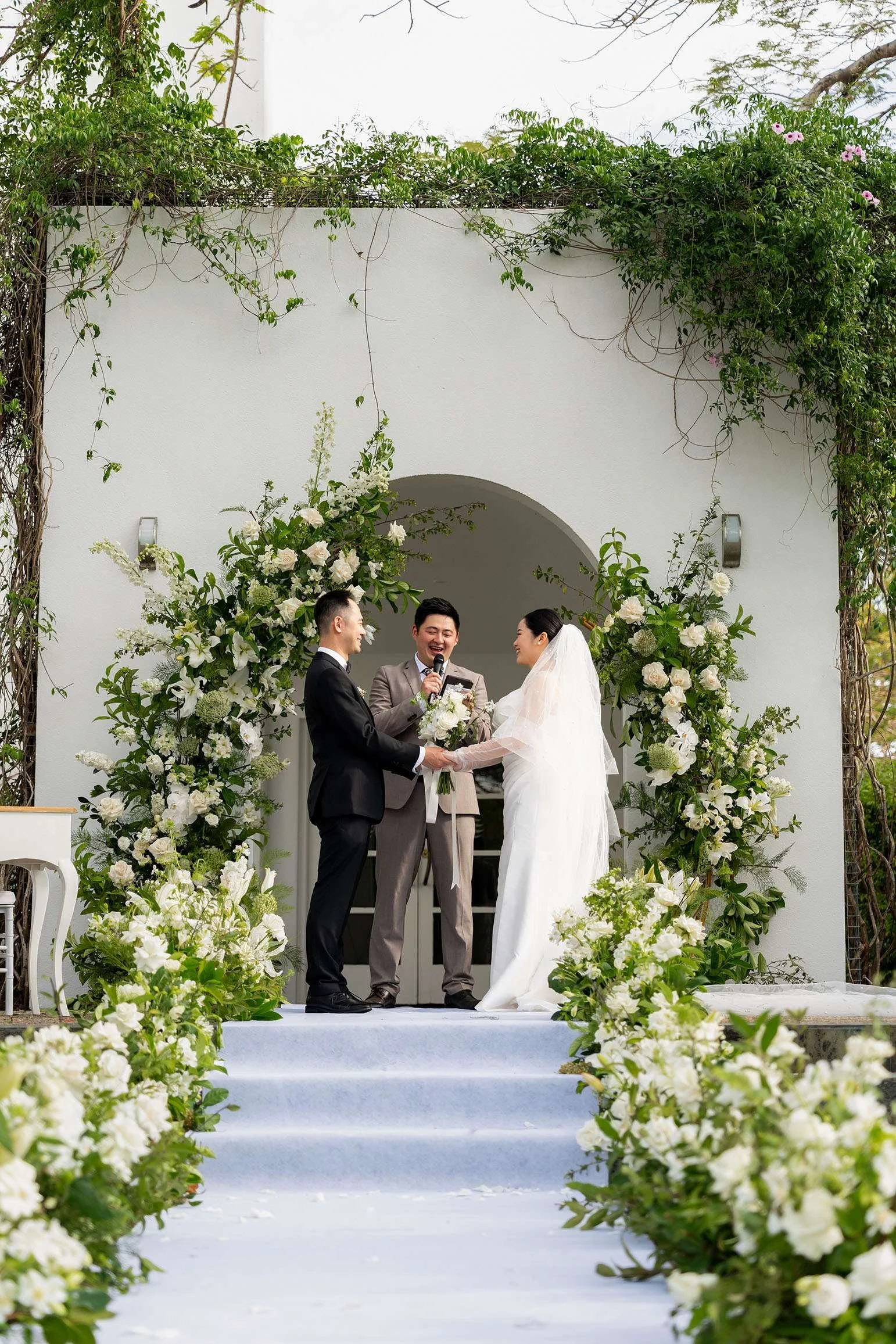 Wendy and Alex facing to each other and celebrant in the middle 