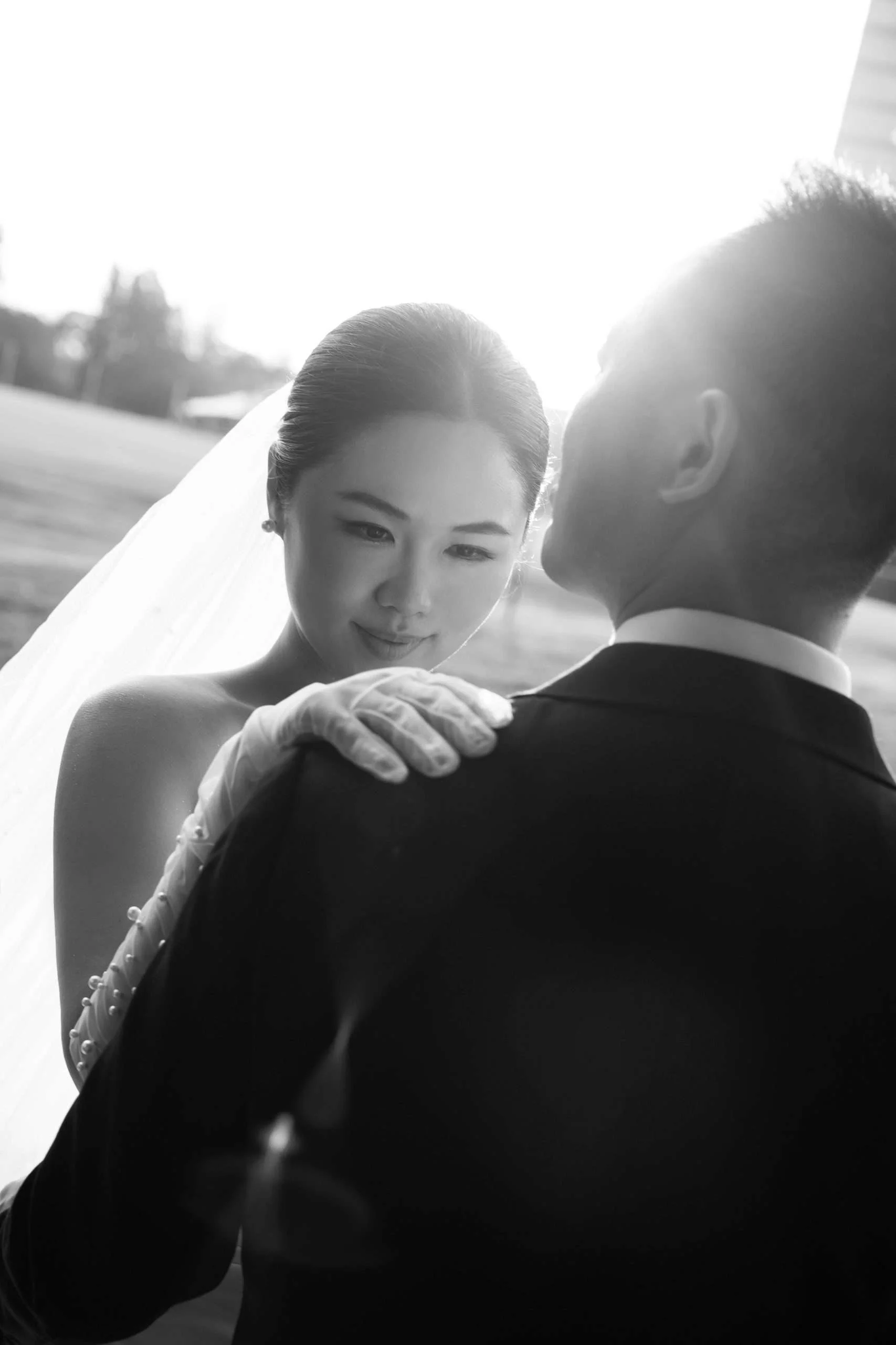 bride Wendy look at groom Alex's chest with one hand on his shoulder