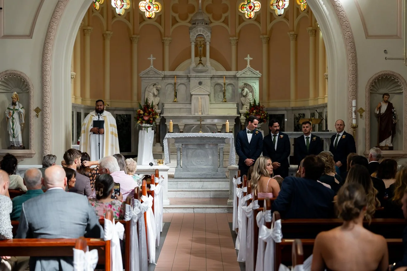 The groom, along with his groomsmen, stood at the front, waiting for the bride to walk in.