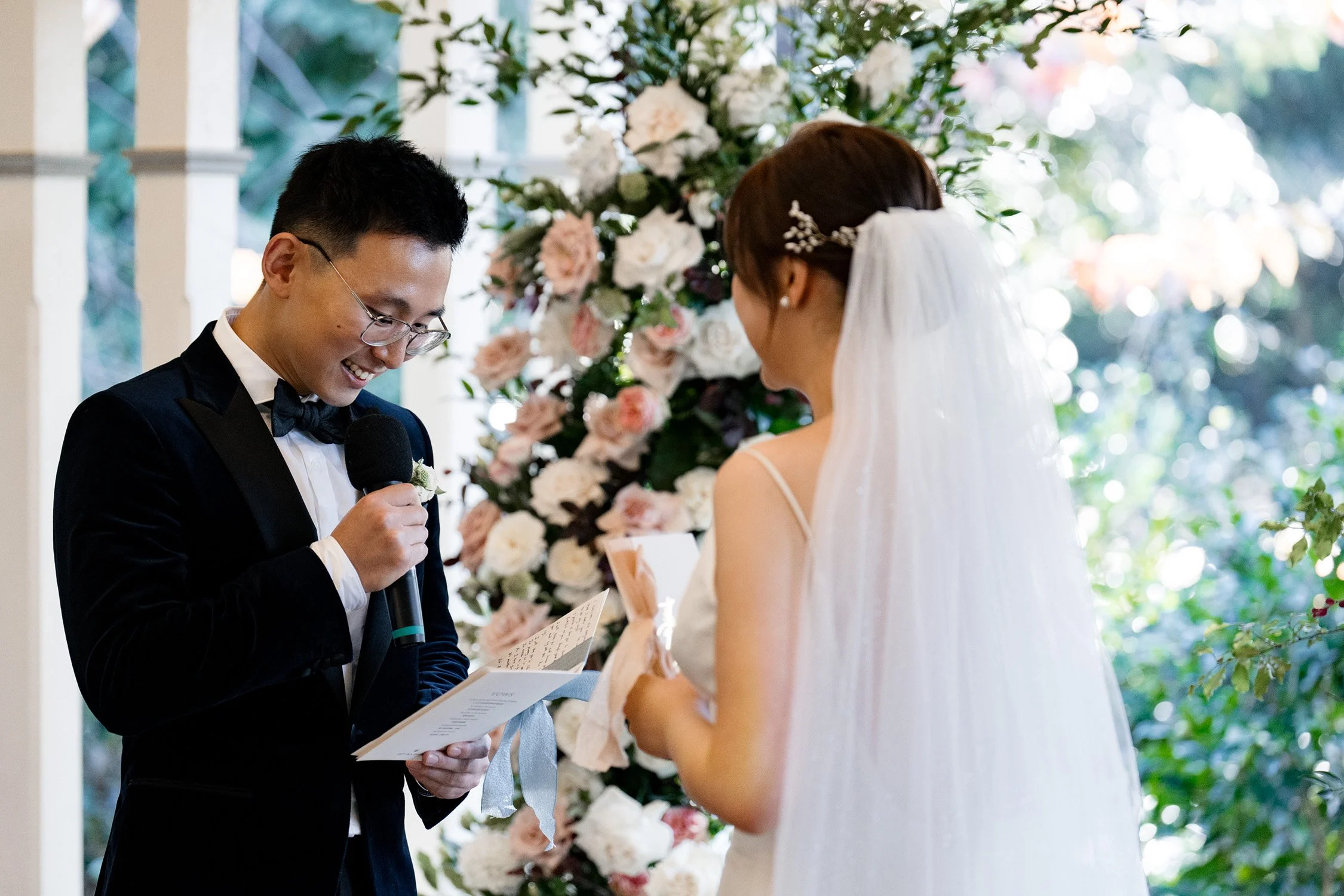 groom Brus reading his vows with laughs