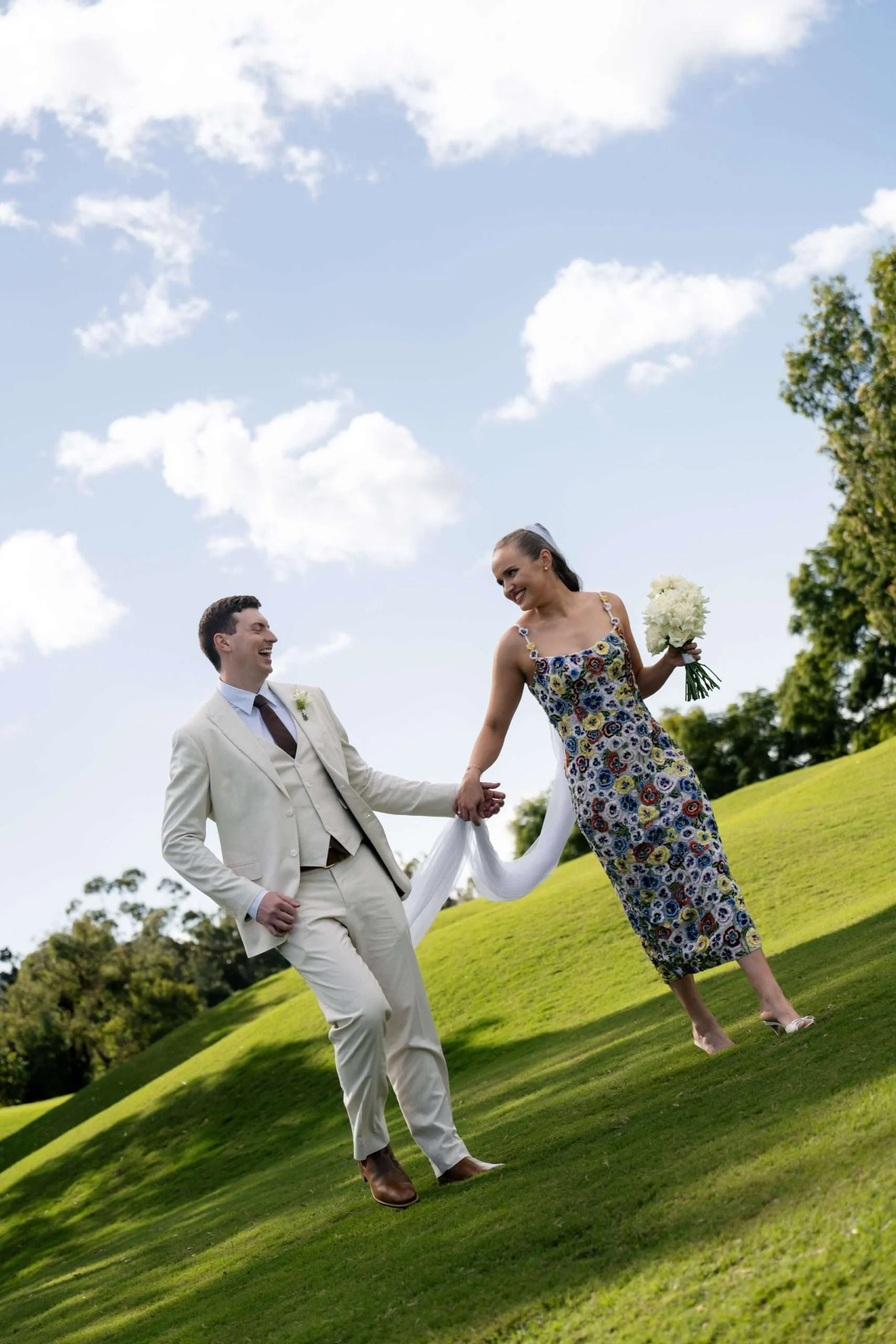 bride and groom hand in hand laughing and walking together