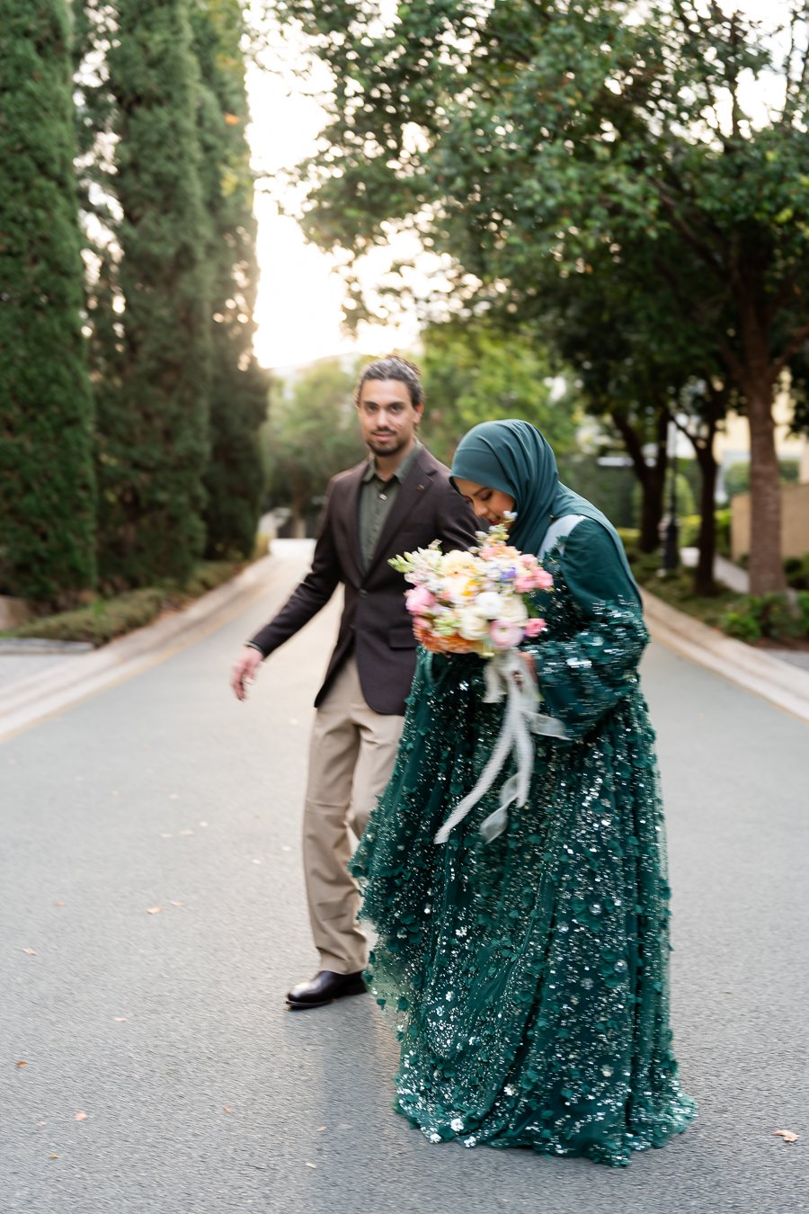 Afifah loook to the floor and Junaid smell look forward in Emerald lakes village