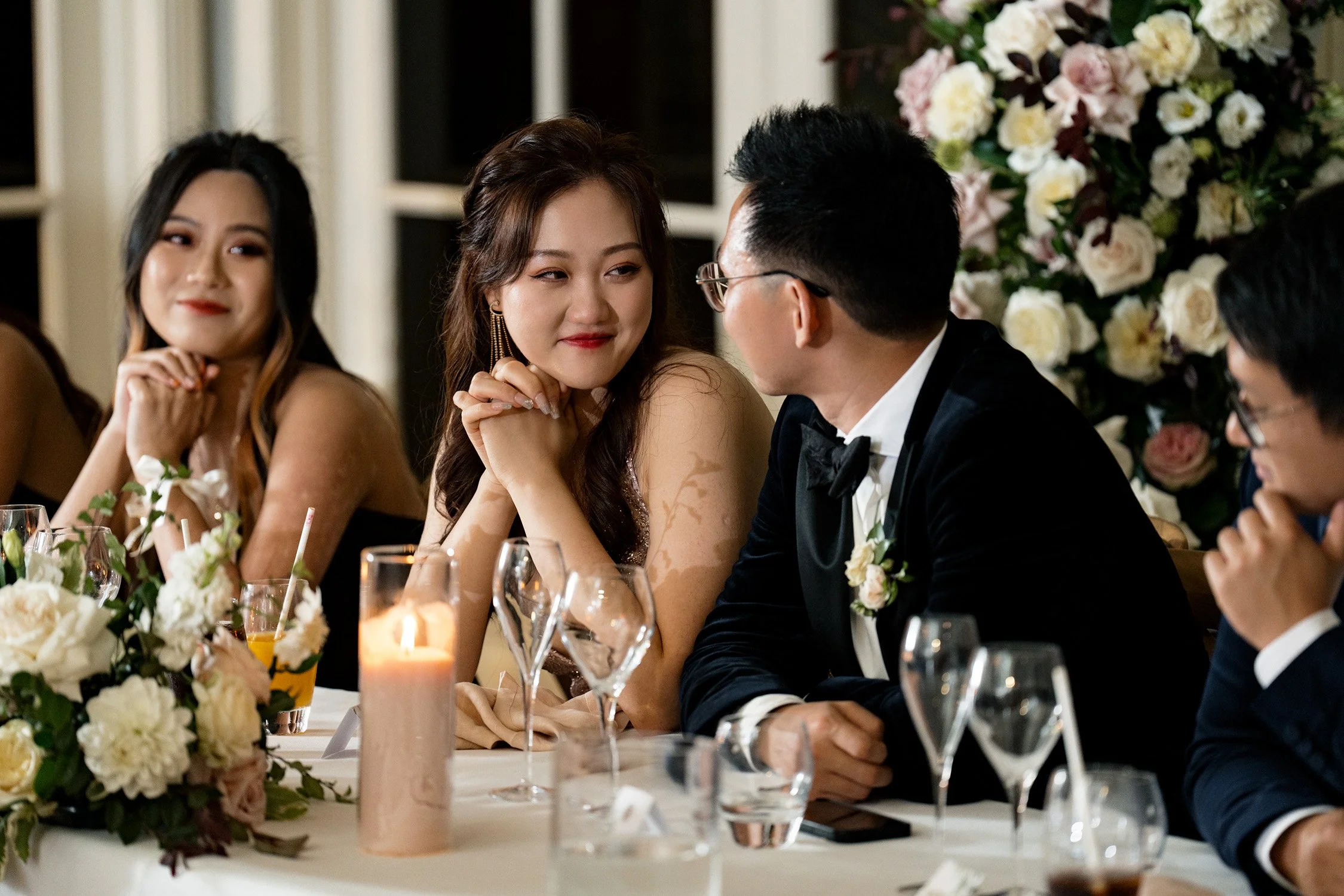 bride Vicky and groom Brus look at each other's eyes when someone making a speech in reception