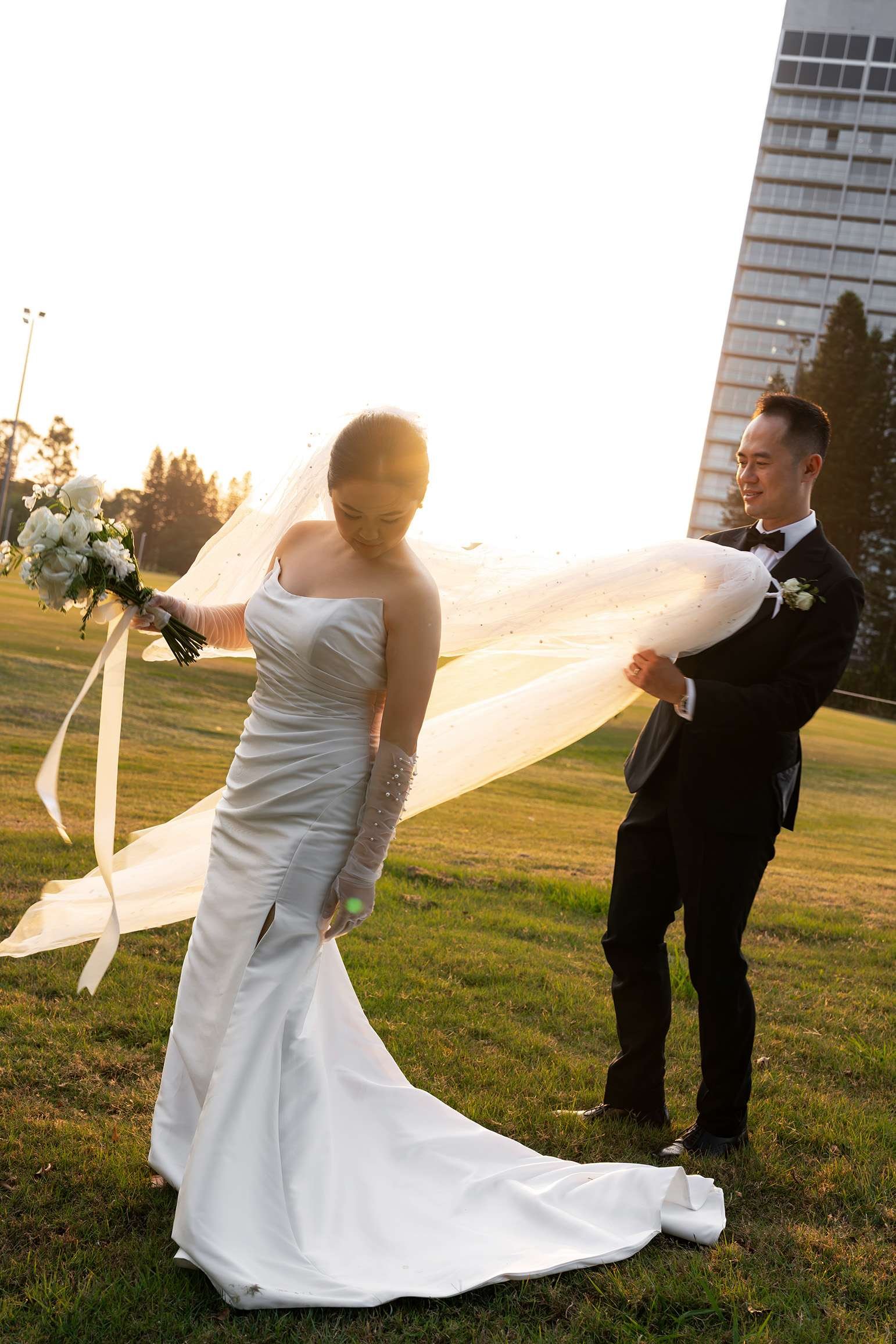 groom Alex holding up bride Wendy's vile and look at her