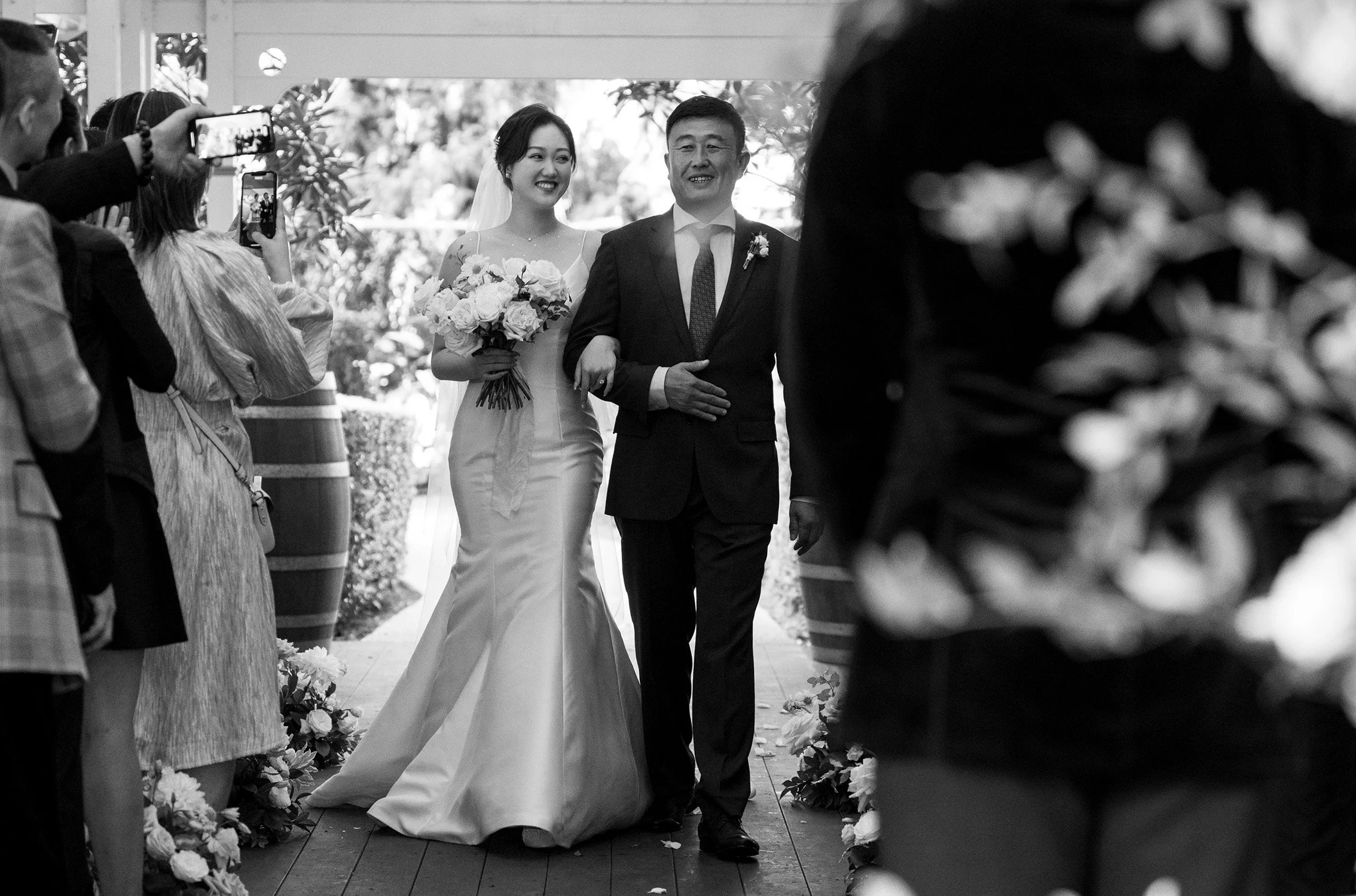 bride Vicky holding her father's arm walking toward to groom Brus in Gabbinbar Homestead
