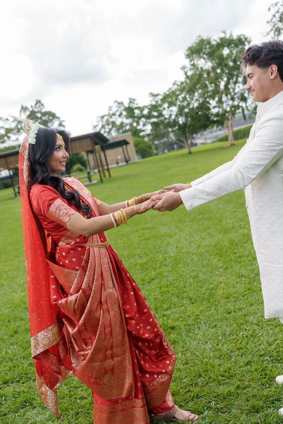 Amrita and Casey stretching arms together while look at each other