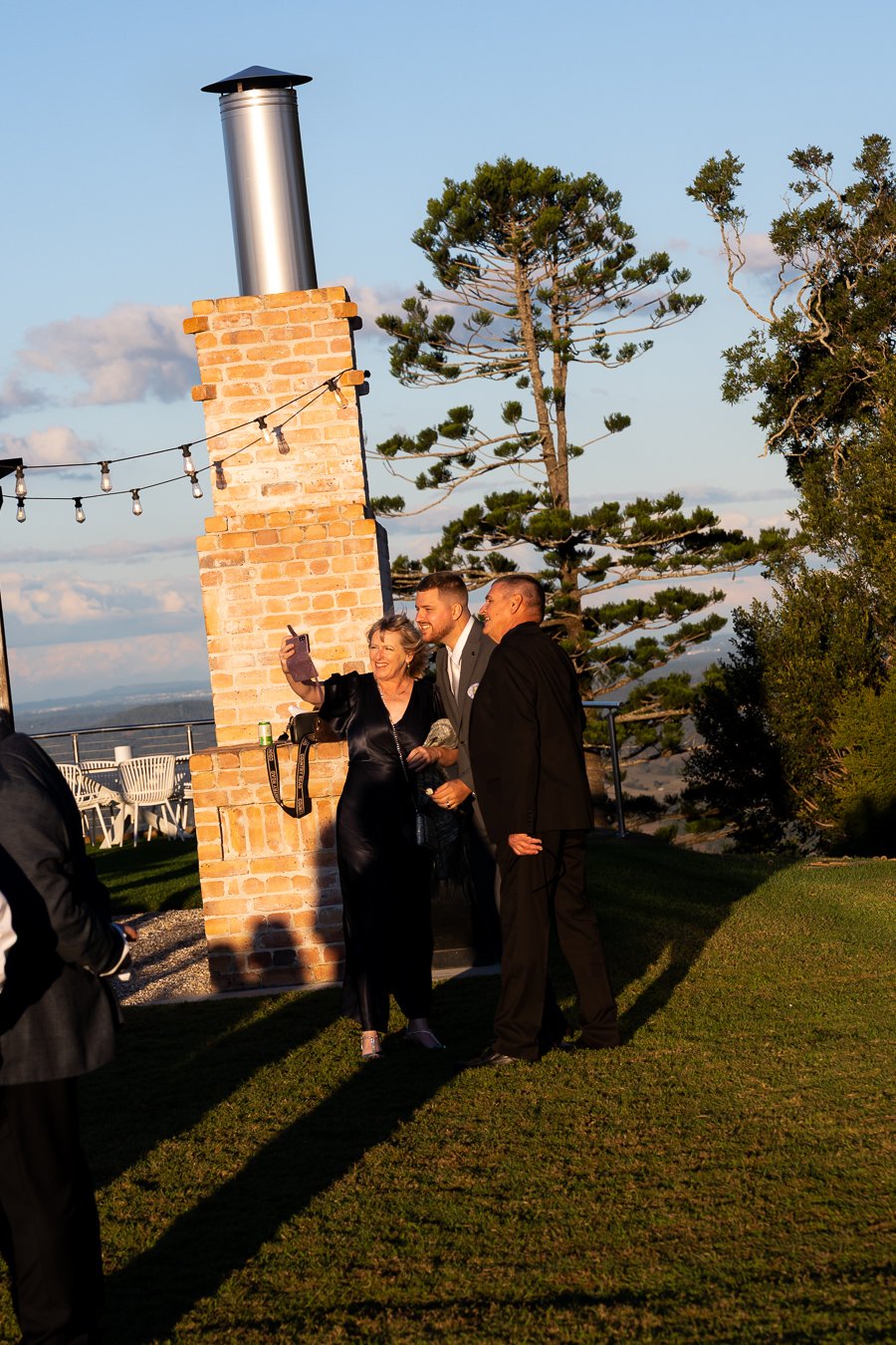 groom Ben taking selfie with two guests