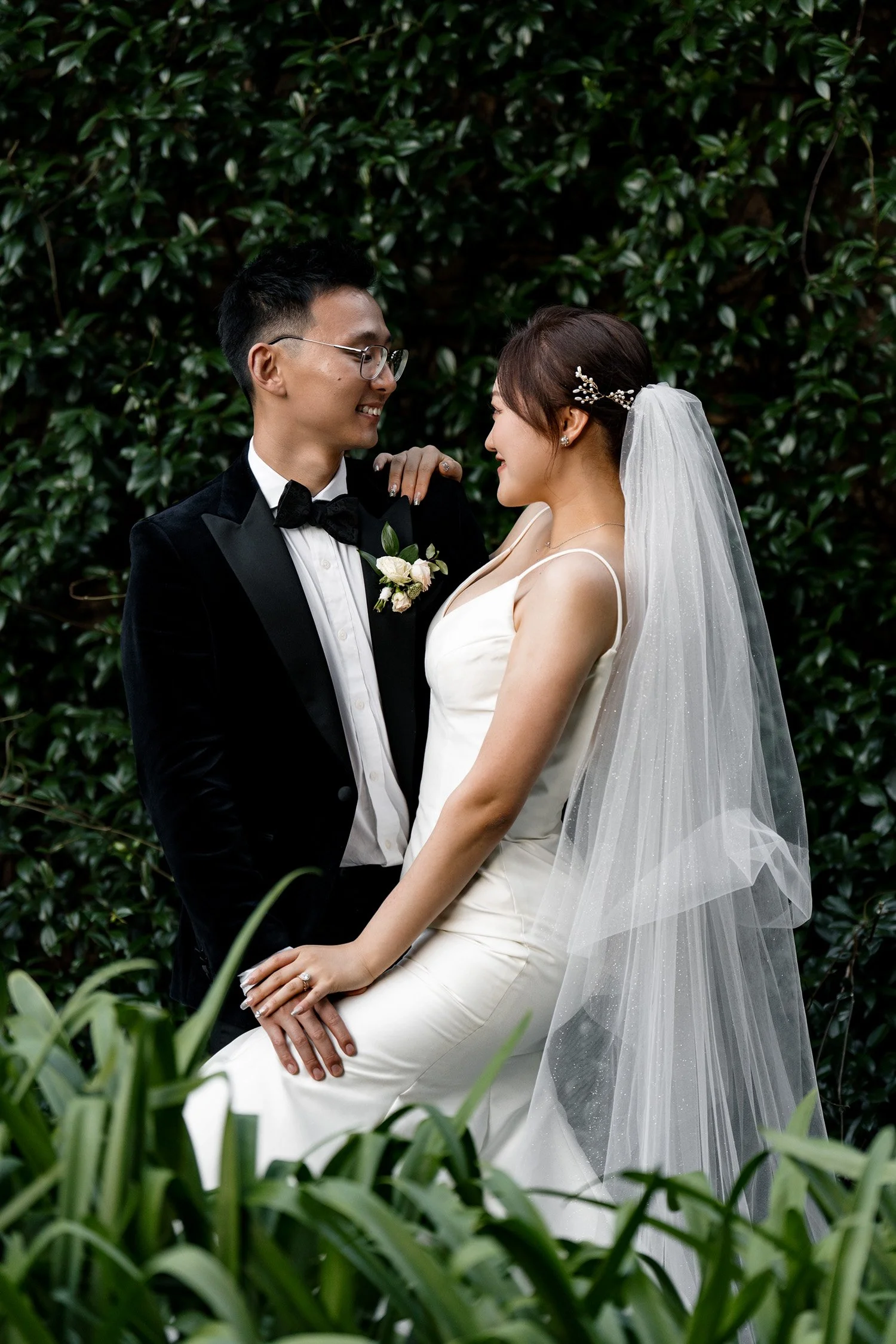 bride holding groom's shoulder and look at him