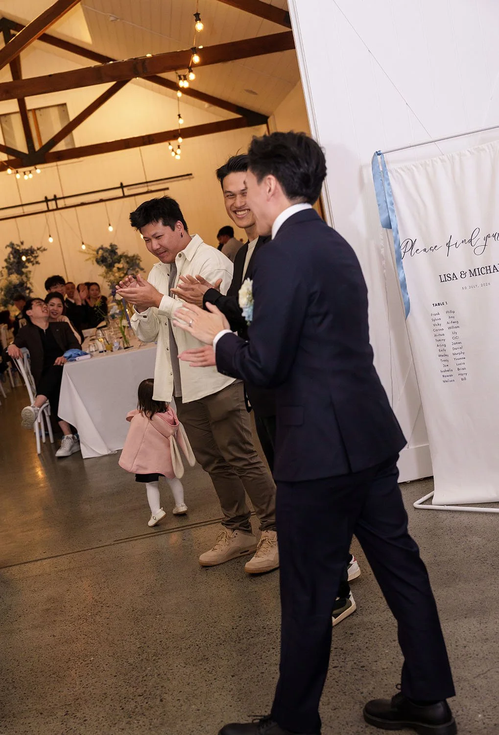 Michael laughing with two guests in reception