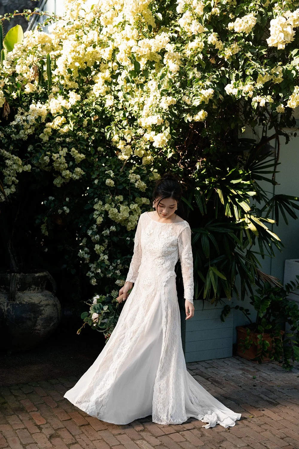 bride Cassie look down to her dress and walk in Wilson Outlook Reserve