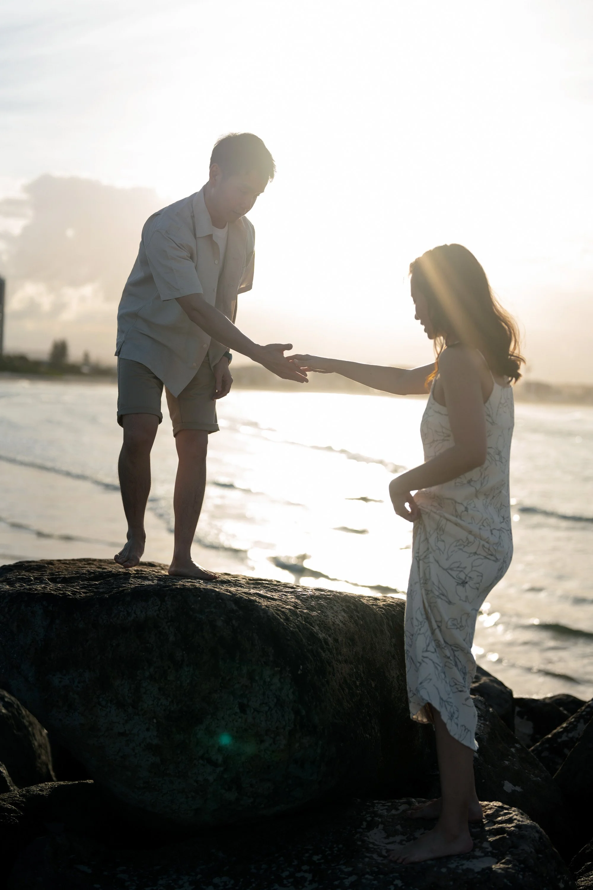 Paul try to hold Krystel's hand and help her walk up to the rock