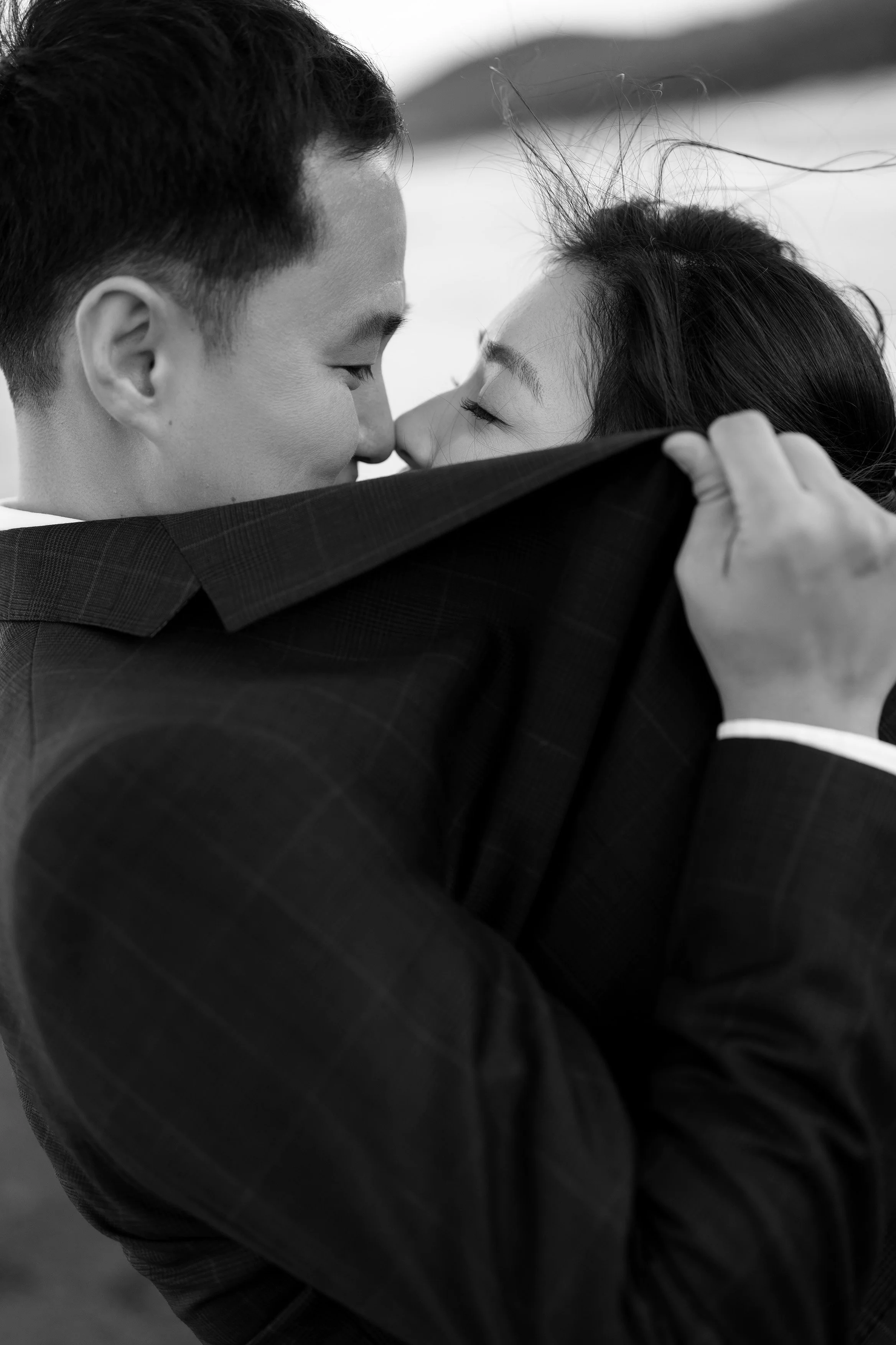 Margaret and Silva kissing behind Silva's jacket only can see their eyes