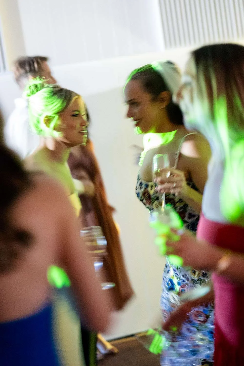 Bride Charlotte talking to a young femal on the dance floor during the wedding reception