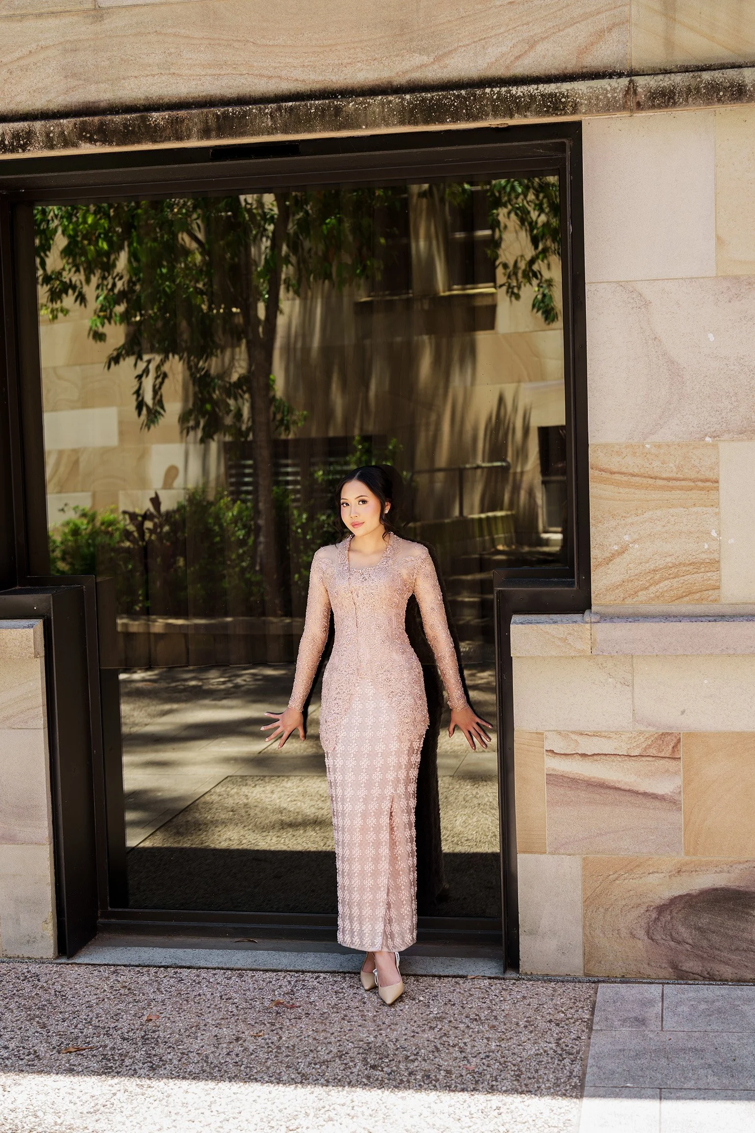 Bella back against the glass window smell to the Brisbane wedding photographer