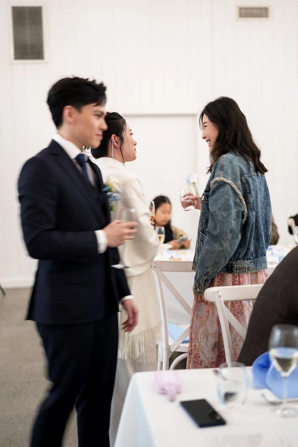 Lisa talking to one of the guests while Michael passing them
