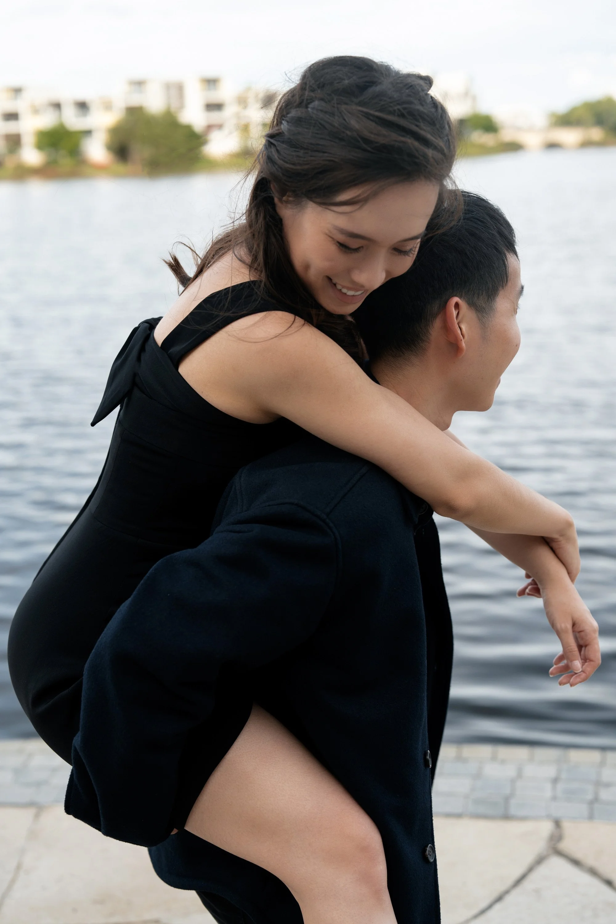 Paul carry Krystel in Emerald Lakes Village, Brisbane engagement photography