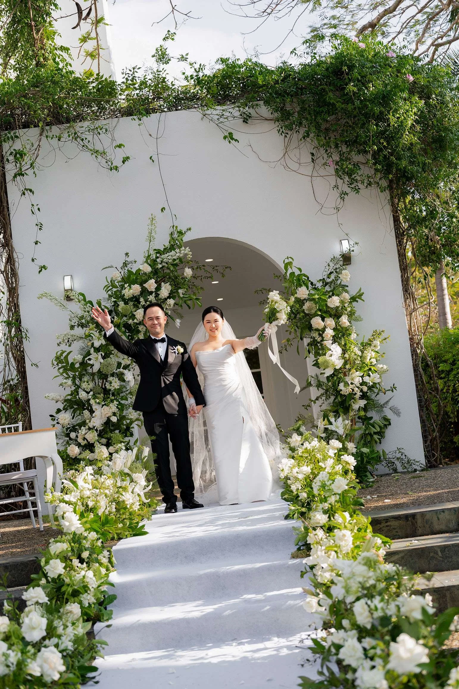 Wendy and Alex wave hands to audience after ceremony in Gold Coast wedding