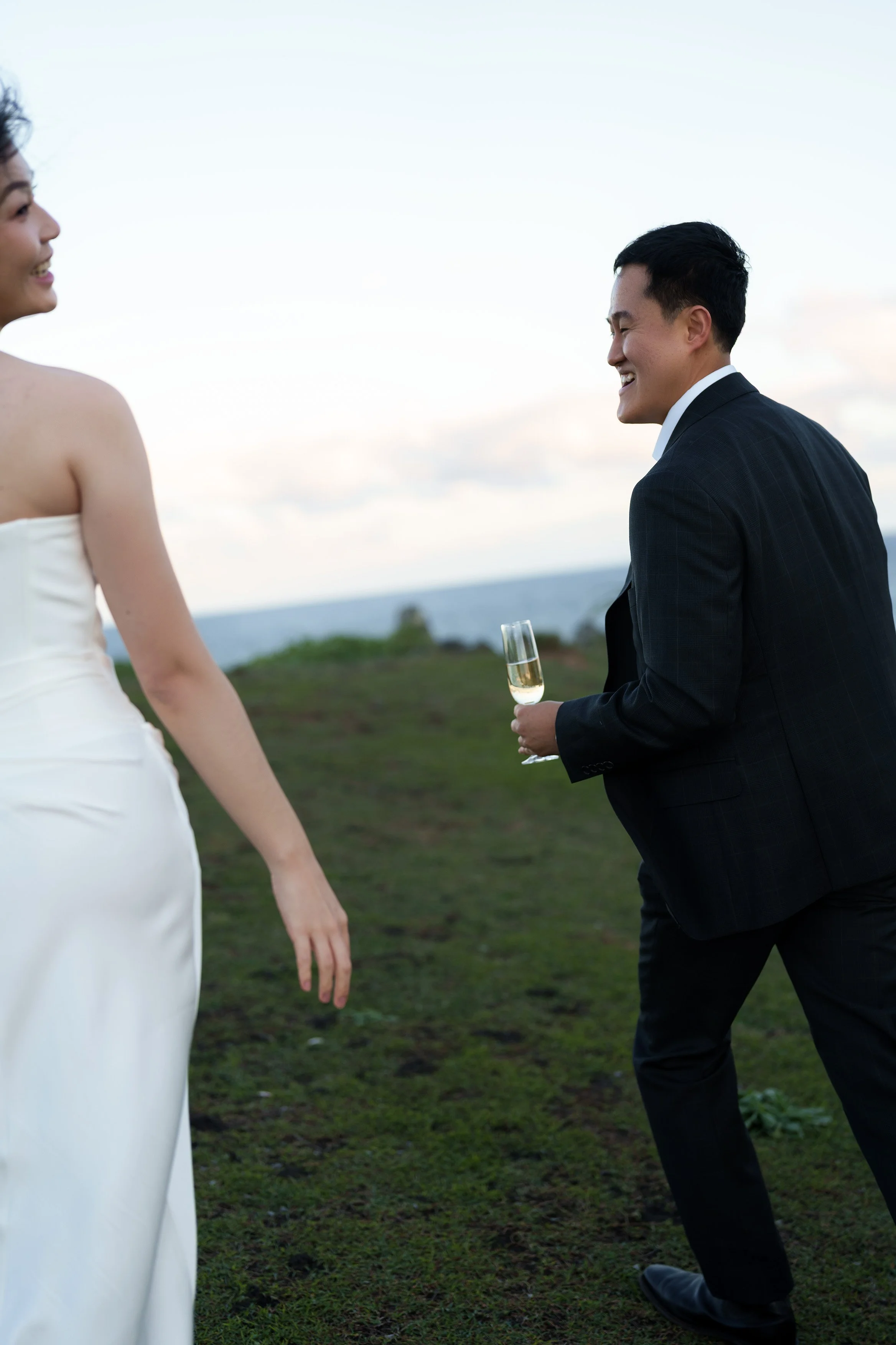 Silva holding a glasses of champagne walking and Margaret walking near him