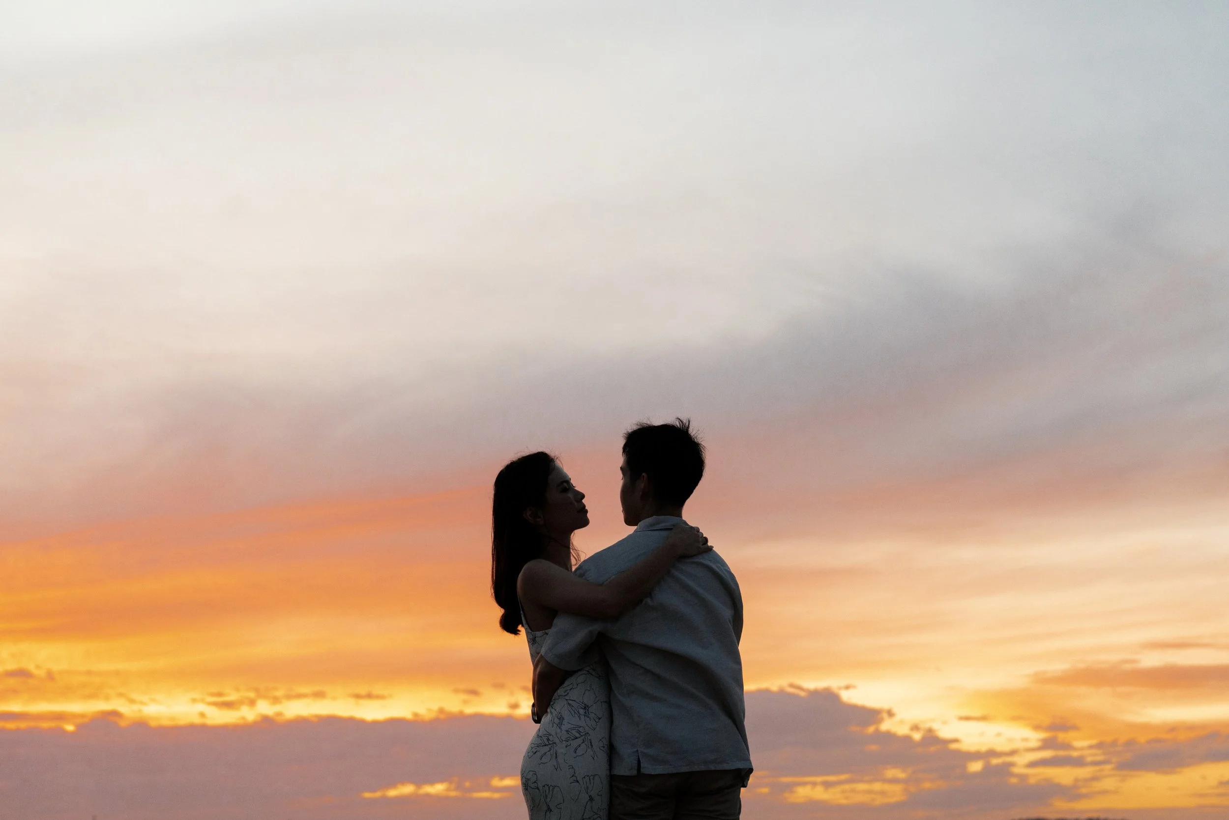 Krystel and Paul holding each other during sunset in Gold Coast Currumbin Rock