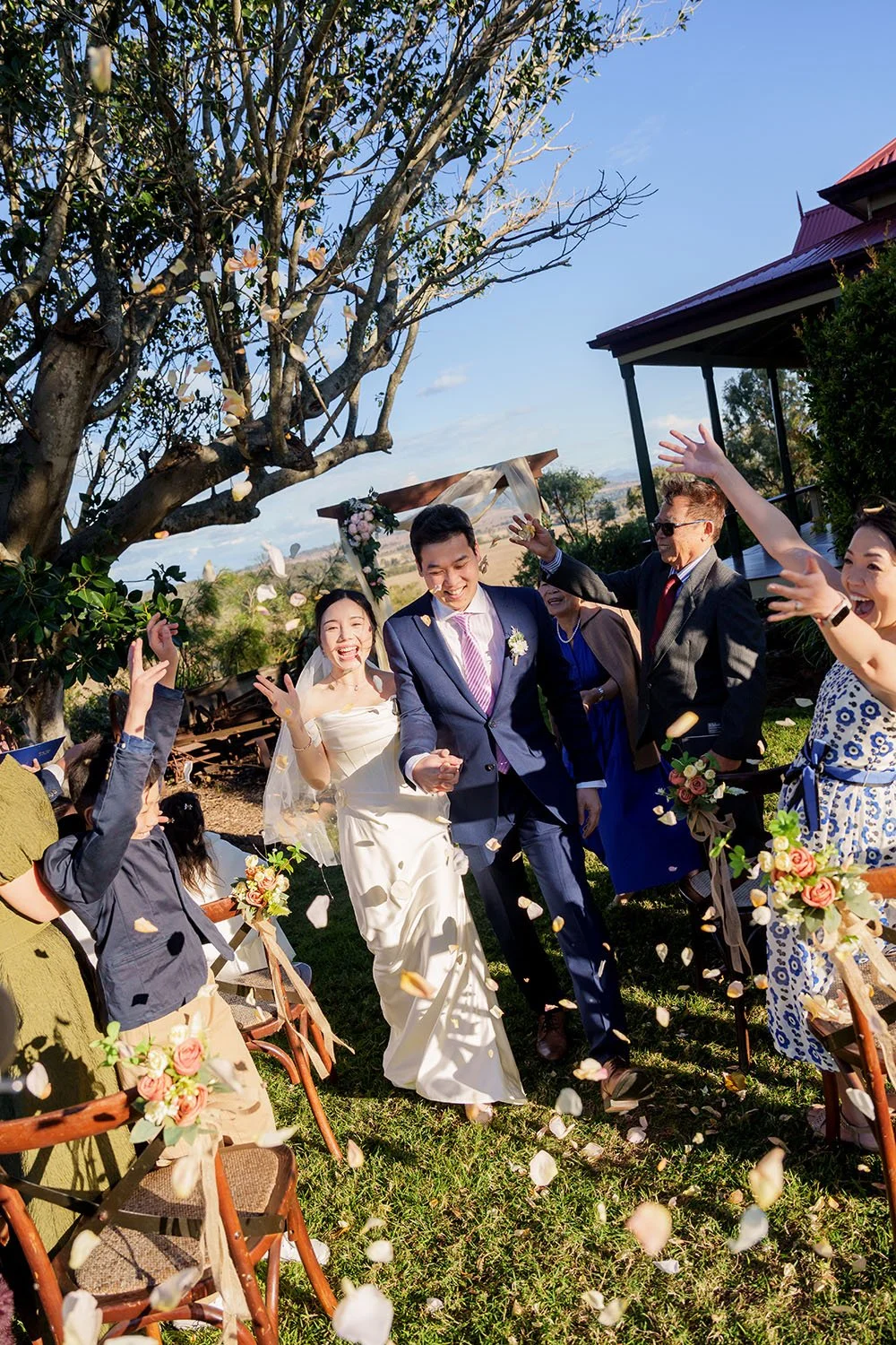 Eric and Flora holding hands walking down the ailse