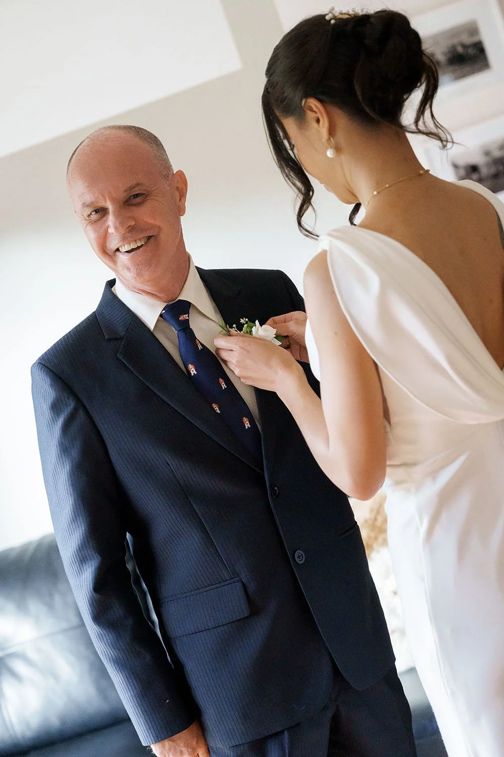 Jasmin put on the pocket flower for her father, while her father look at there