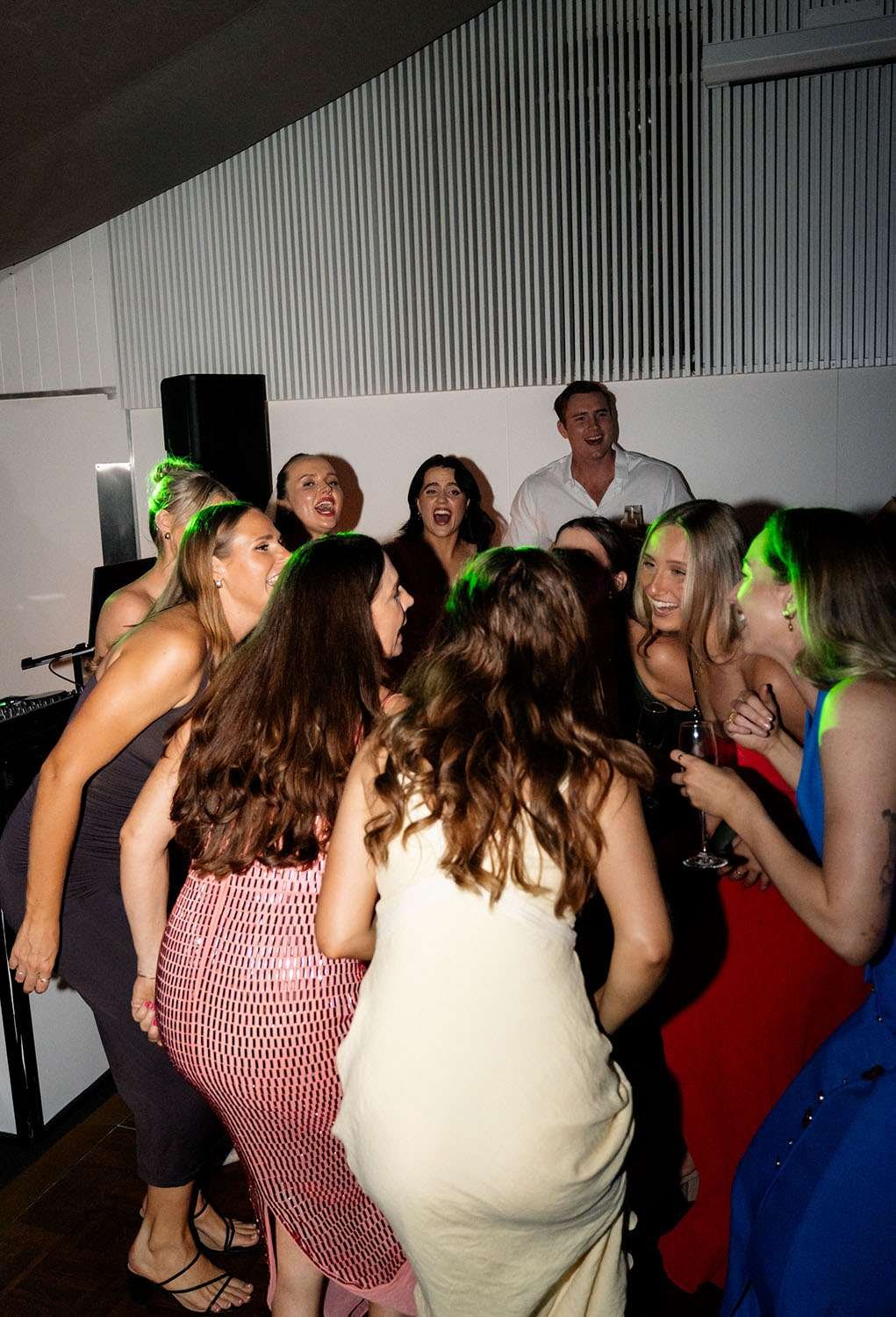 guests in a circle singing in dance floor