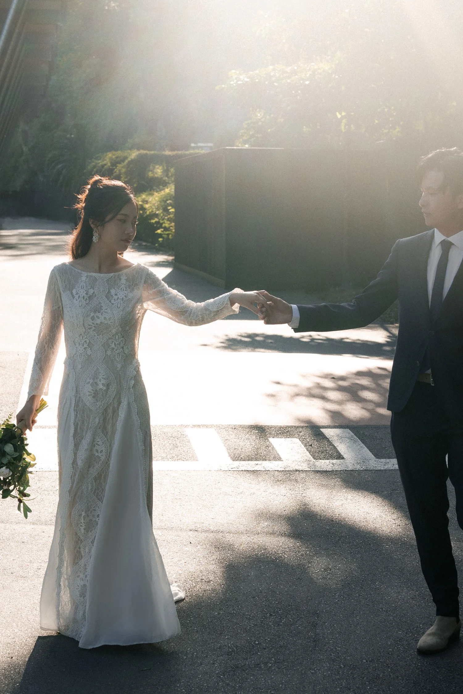 bride and groom holding hands walking together when they both look at hands in Wilson Outlook Reserve