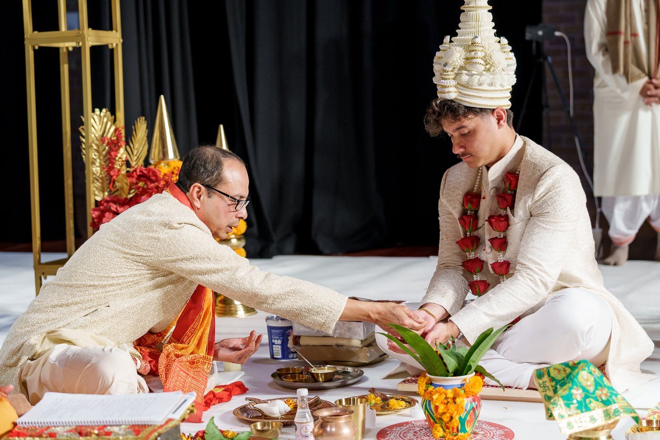 a male passing some rice to Casey to his hand
