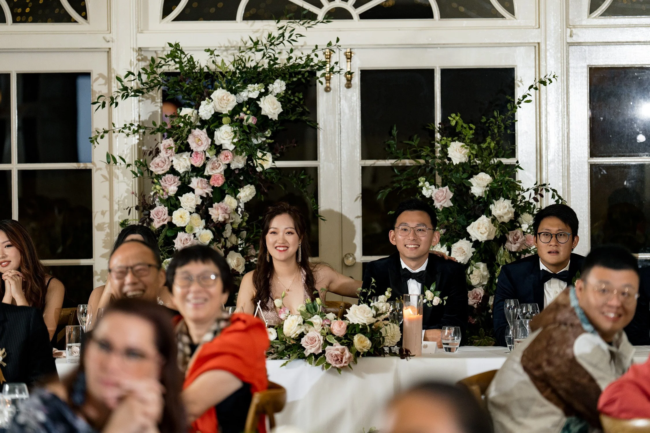 bride Vicky and groom Brus look at the front when sitting back at bridal table in Gabbinbar Homestead