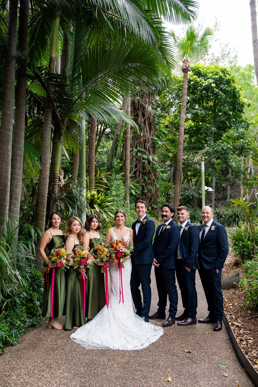 bridal party stand in a line look at the Brisbane wedding photographer Whistler Li