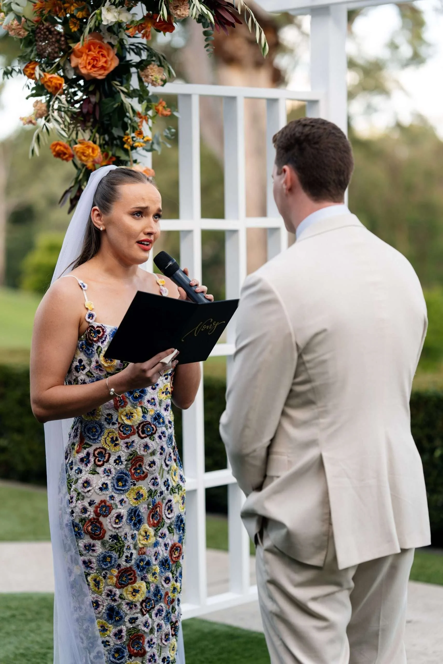 bride Charlotte making her vows while look at into groom's eyes almost cry