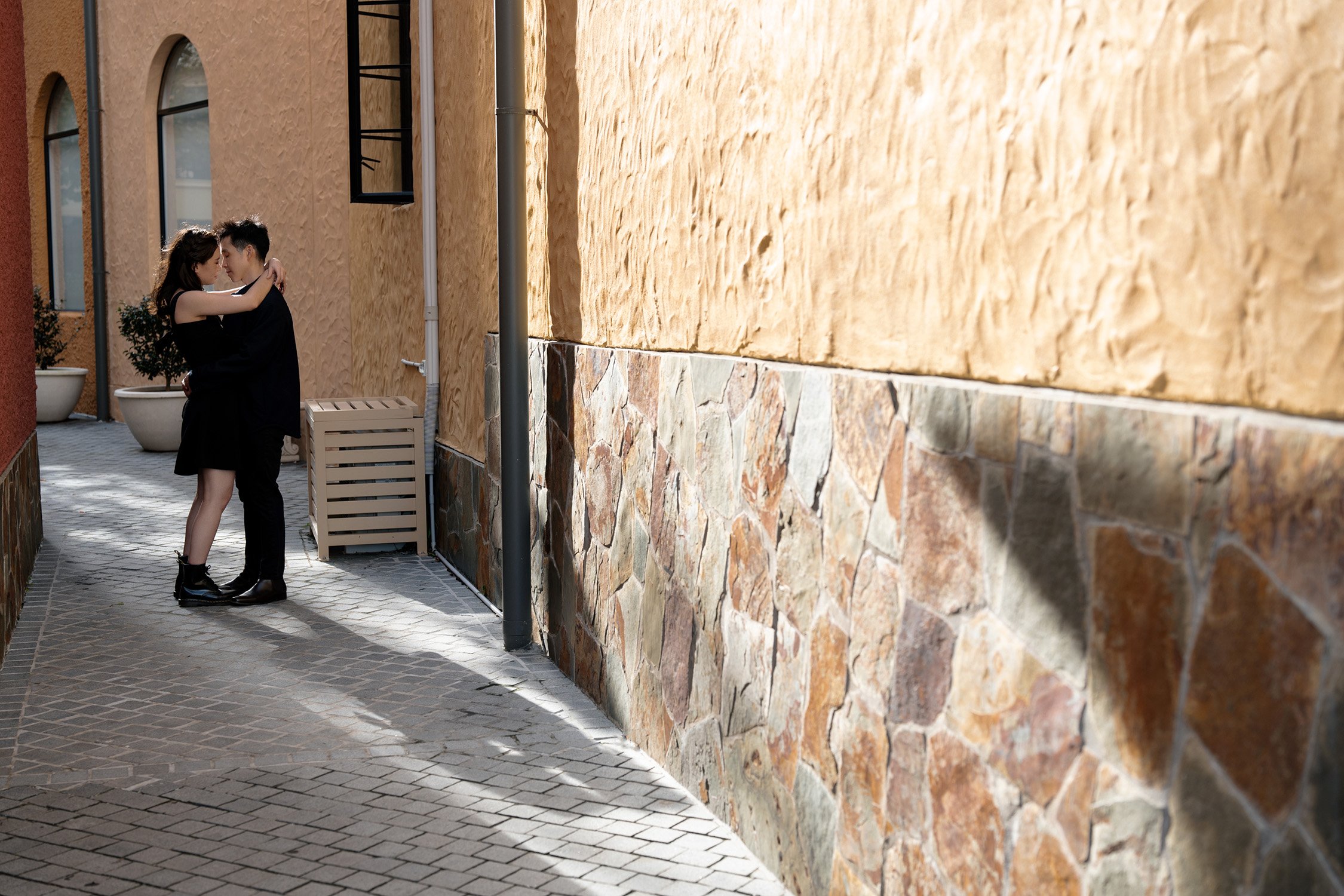 Paul and Krystel try to kiss with a back sun light