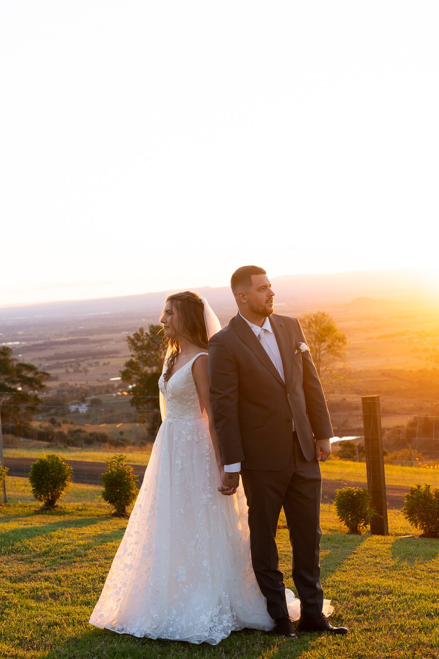 Chiarra and Ben back to back look stright ahead and hand holding