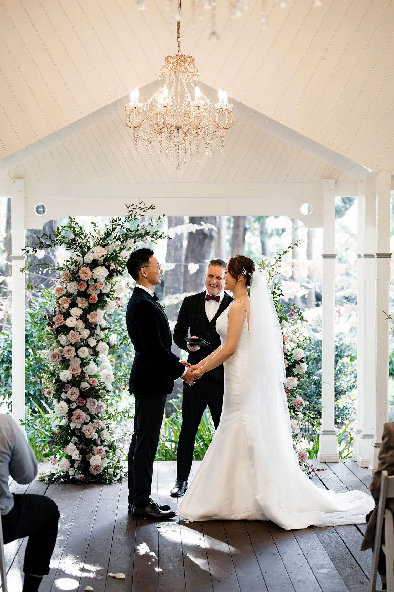 bride and groom holding hands in ceremony and both laughing in Gabbinbar Homestead
