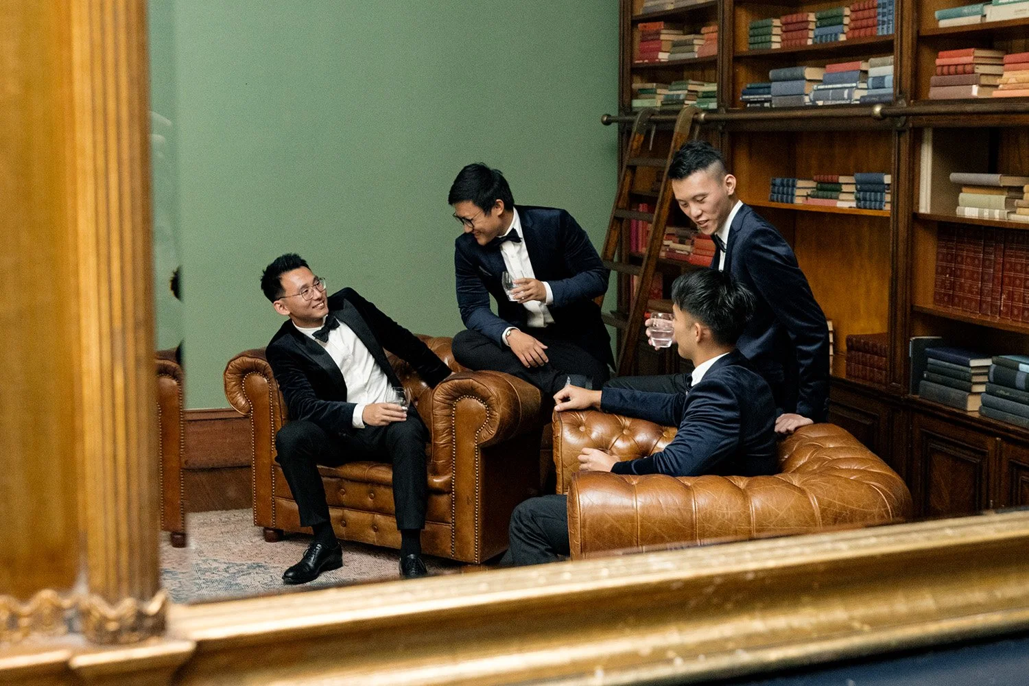 groom Brus talking to his groomsmen when holding a drink