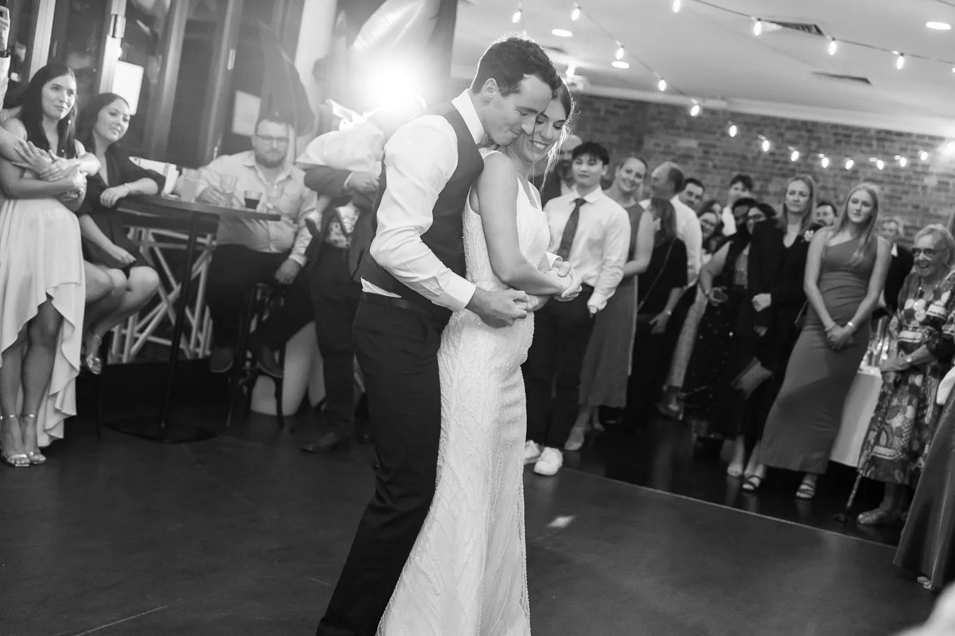groom Giordan holding bride Sonya from behind in their dance