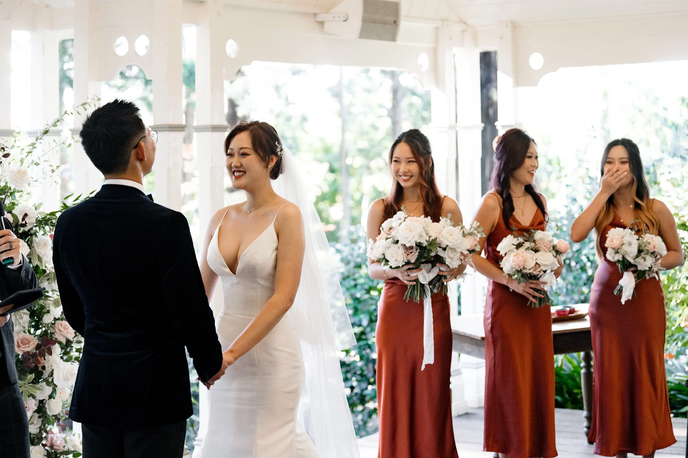 bride look at groom Brus and bride's mates laughing at the background in Gabbinbar Homestead