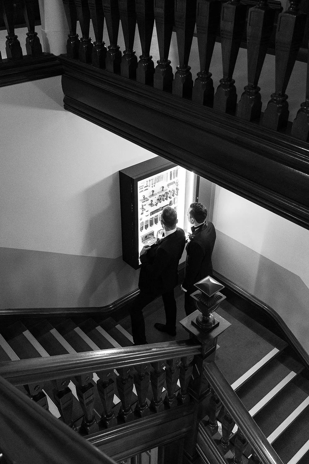 groom Cliffe and his groomsman look inside a led box