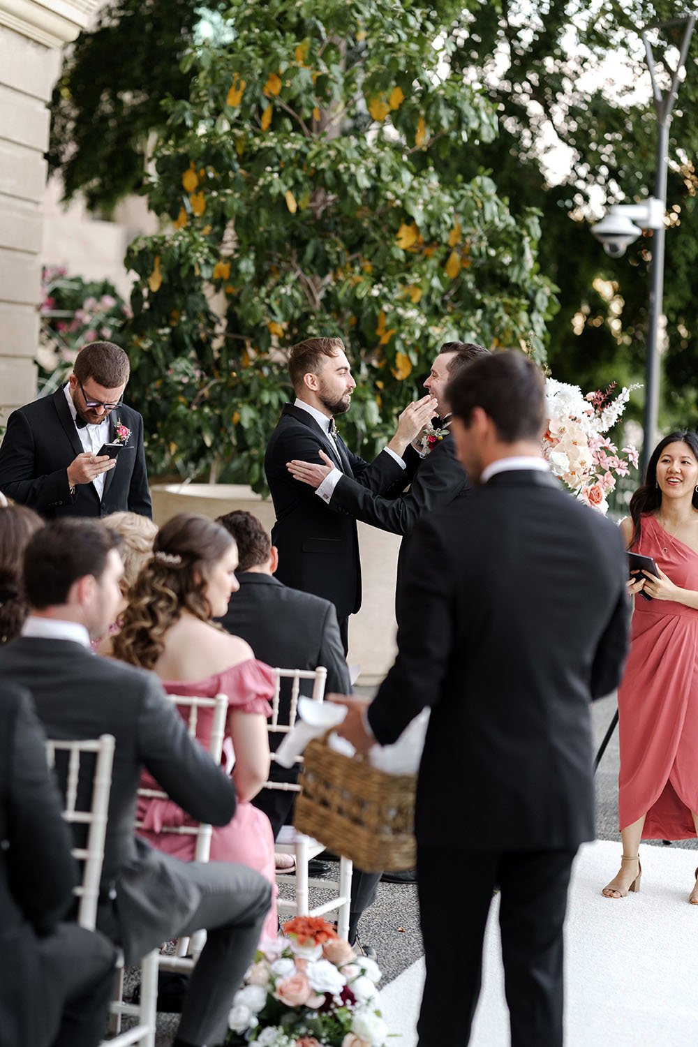 The groomsman giving the groom some final touches before the ceremony starts