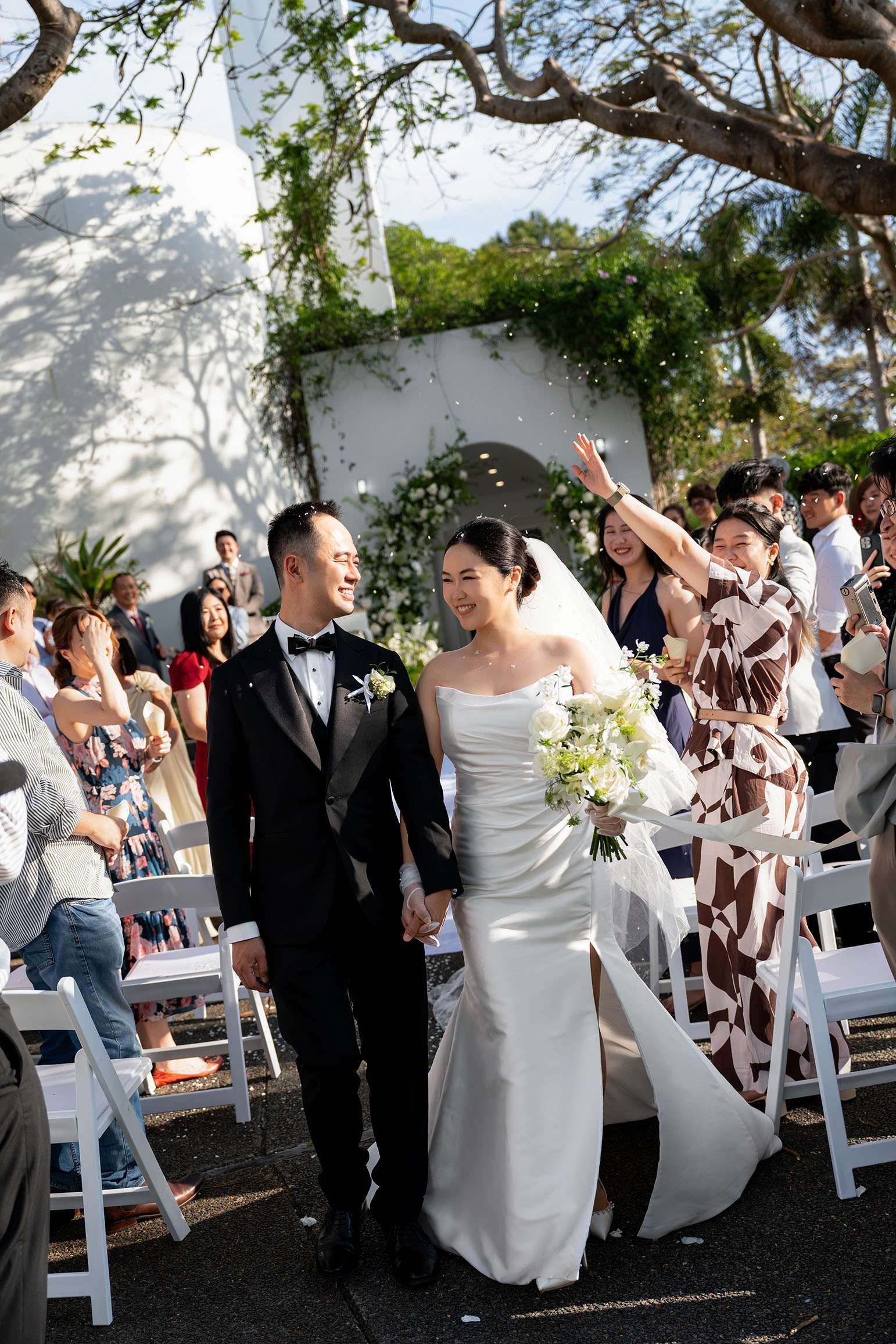 Alex and Wendy holding hands walking down the aisle after wedding ceremony