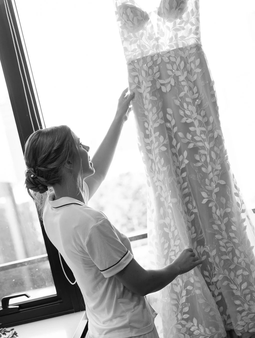 bride Sonya try to reach her wedding dress and look at it