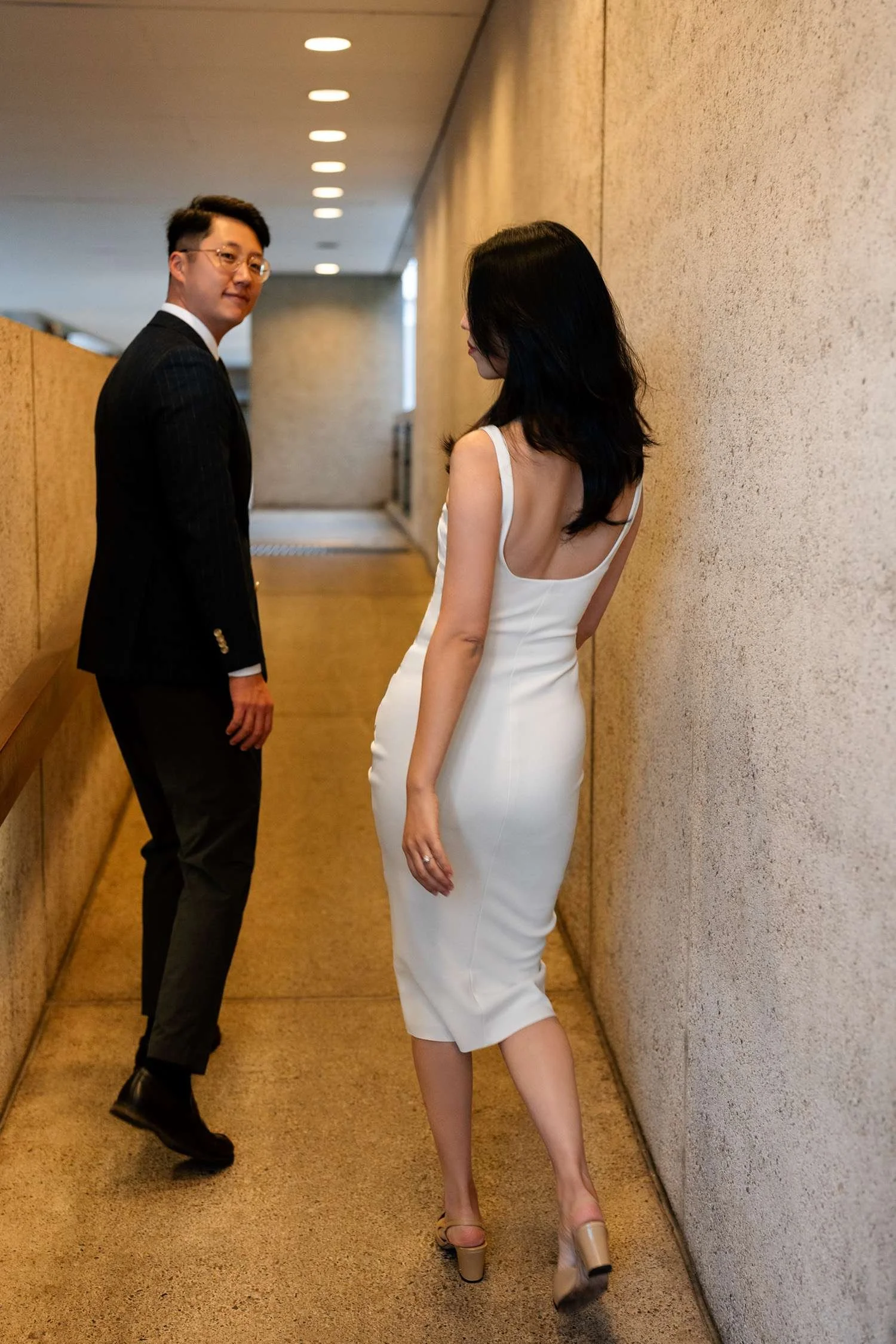 Dave glancing back at the camera with a playful expression as Kath follows closely behind, creating a charming and candid moment