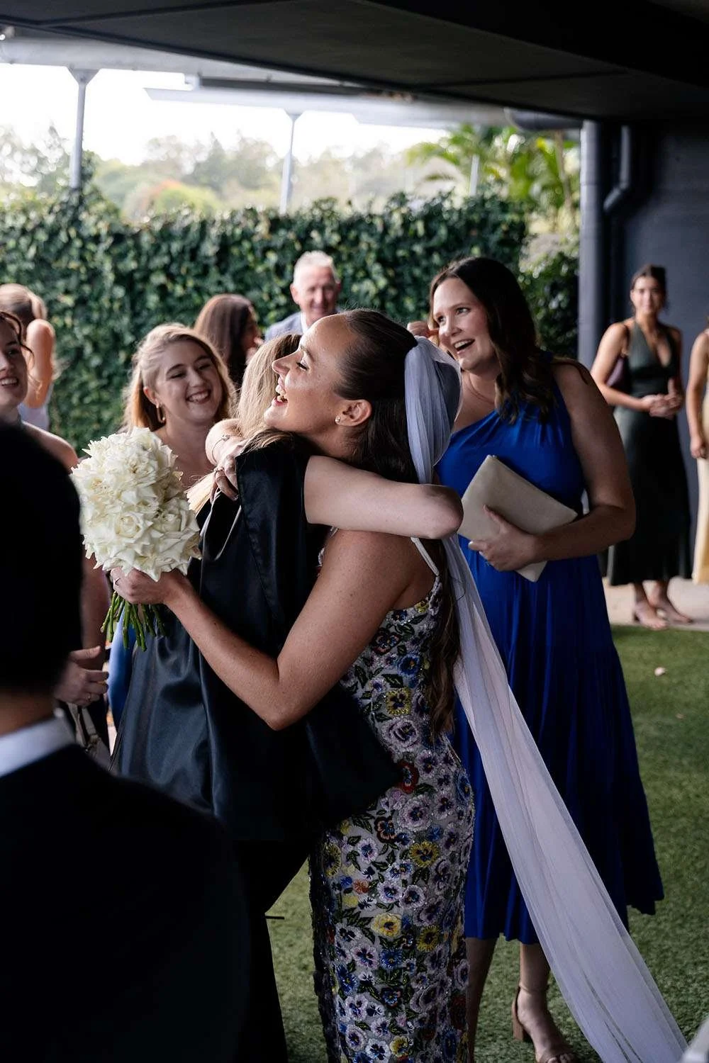 bride Charlotte hugging one of a female guest