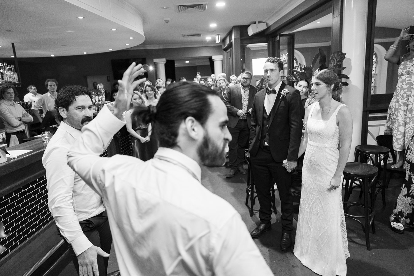 two guests are doing a haka in front of bride and groom