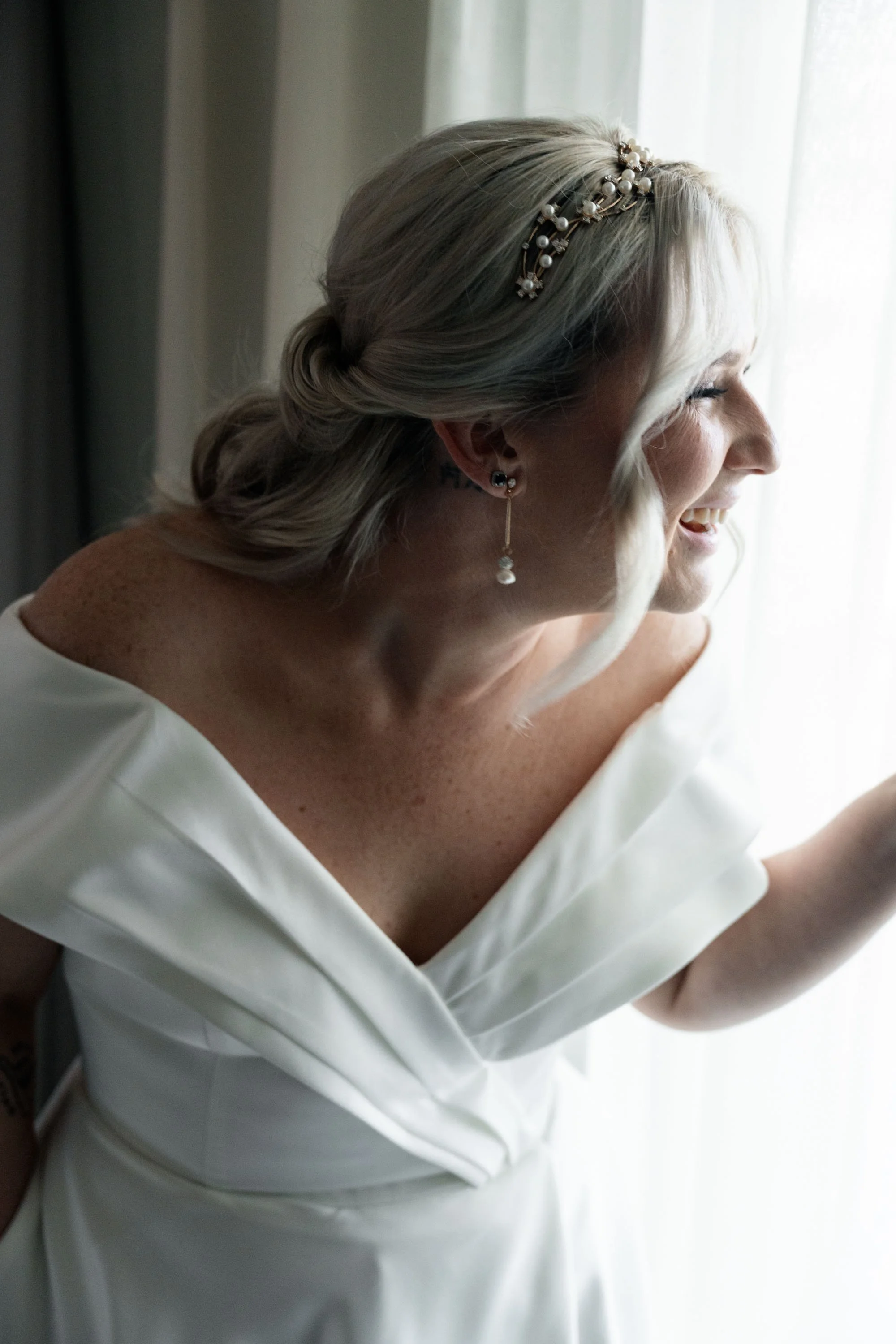 Kyra, the bride, laughing joyfully, radiating happiness and excitement on her wedding day