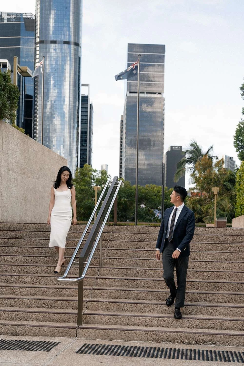 Kath and Dave walking down the stairs together, hand in hand, capturing a graceful and intimate moment as they descend with ease and joy