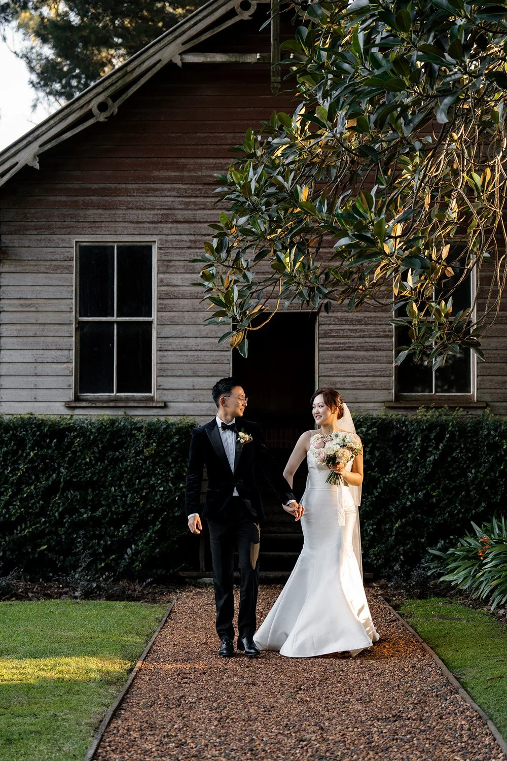 bride Vicky and groom Bruce holding hands walking towards to the wedding photographer Whistler Gabbinbar Homestead wedding