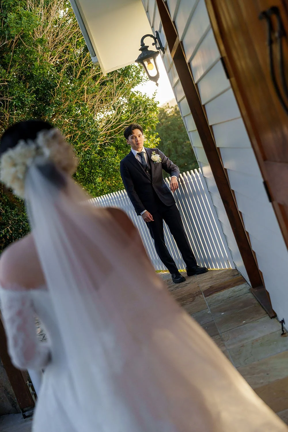Michael stand next to the white fence look to Lisa